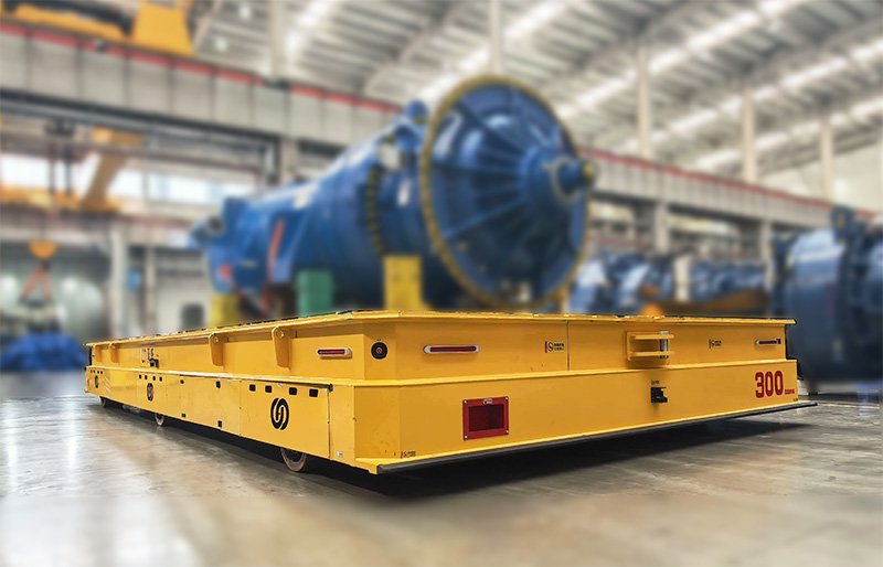 HENSEN 300t Heavy-duty AGV transporting wind turbine components in a  manufacturing plant.