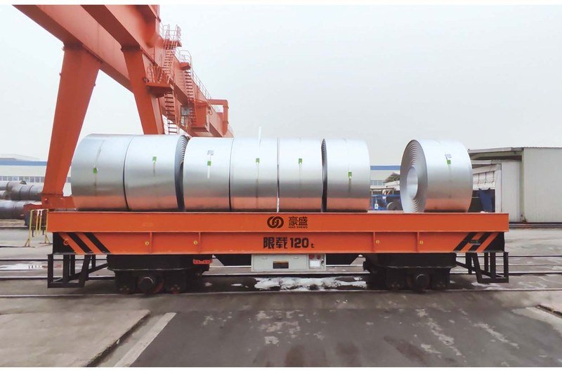 120-ton rail guided vehicle (RGV) transfer cart on steel rails in an industrial workshop